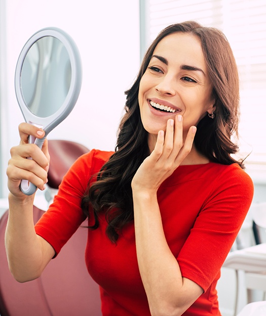 Woman looking at healthy smile after dental checkups